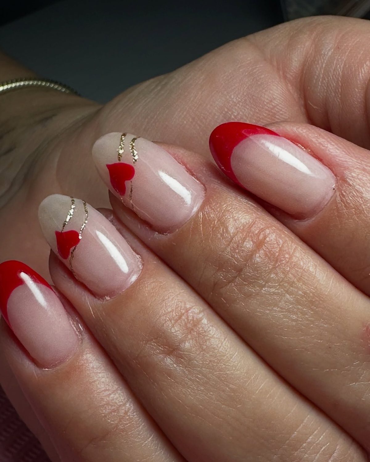 Red French tip acrylic nails with gold glitter hearts at Lietynails