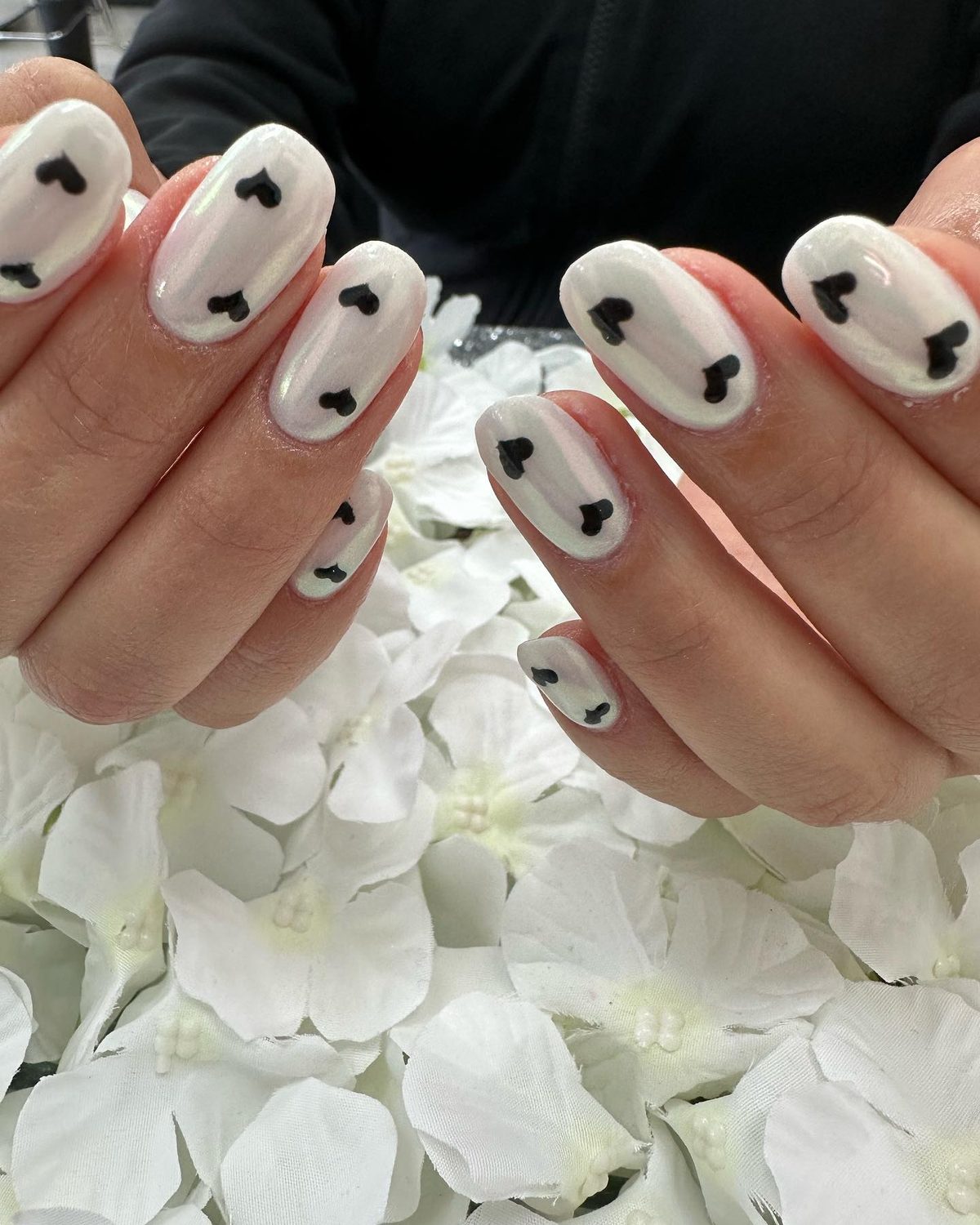 White chrome nails with black heart art at Lietynails